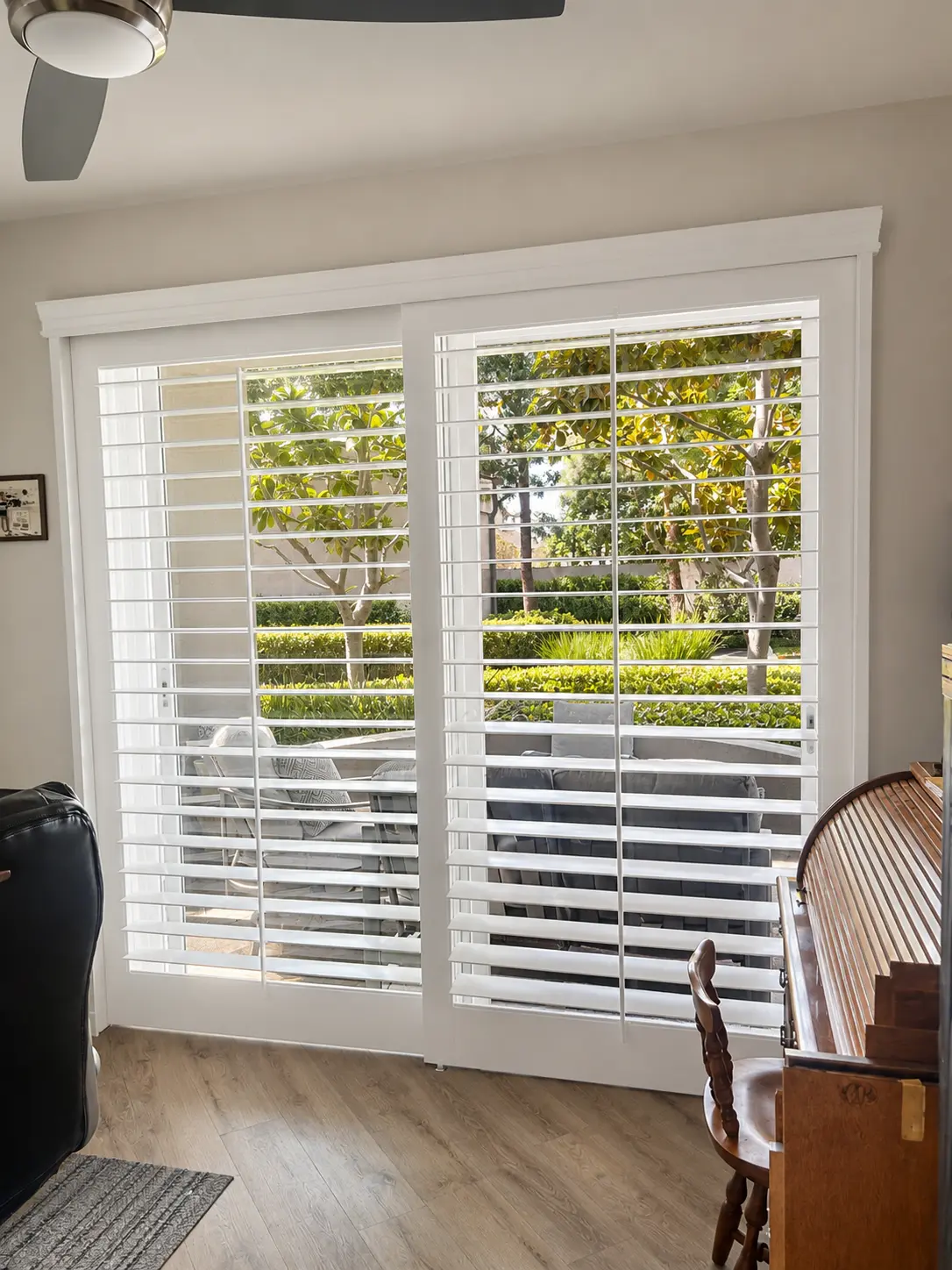 Two-panel sliding plantation shutter system on a living-room patio door